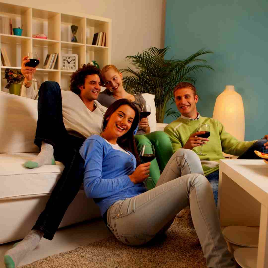 A group of friends watching tv at home.