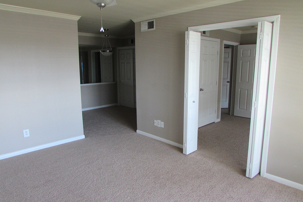 Interior look from the living room into the galley kitchen and the bedroom.