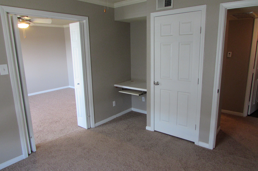 A look from the living room into the bedroom and bathroom. In between either doorway is a place for you to place a computer and work or study.