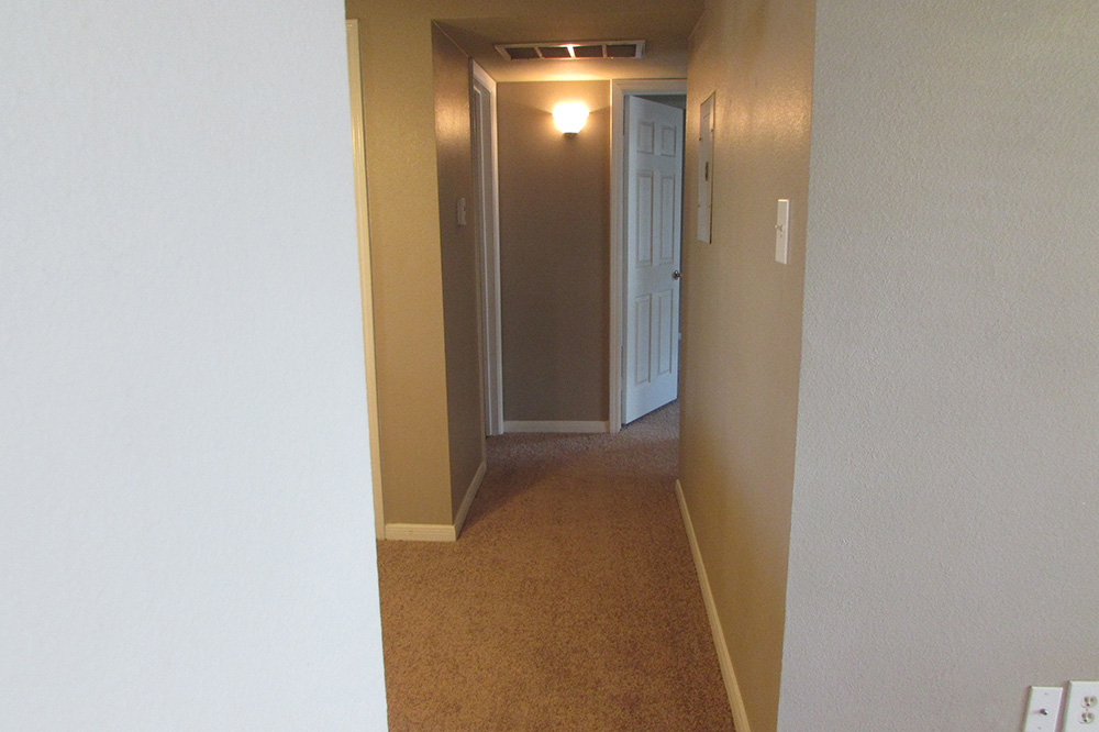 An interior look at the hallway leading to a bedroom.