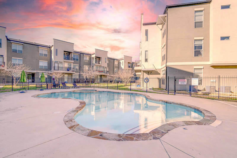 Millennium exterior featuring a pool and a modern building.