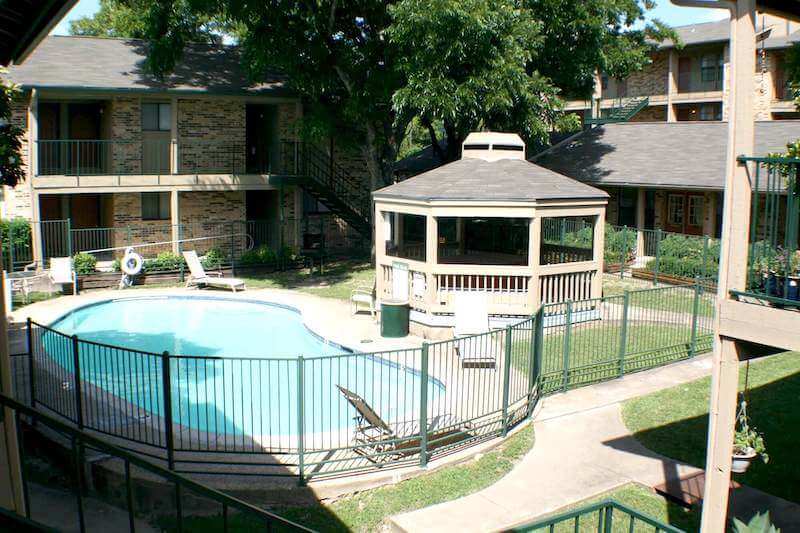 Stadium View apartments exterior featuring a pool and a gazebo.